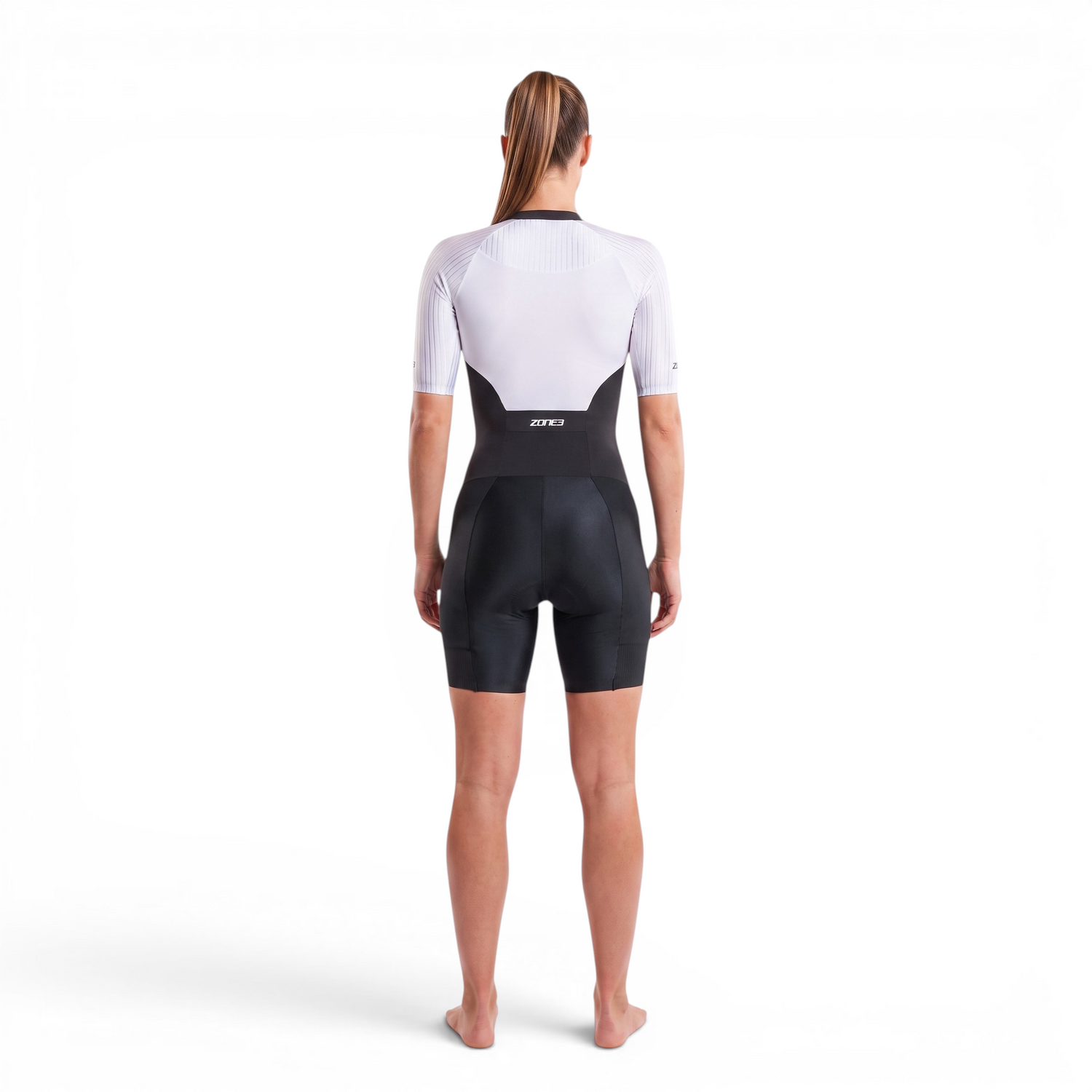 A woman wearing the Zone3 Lava full zip short sleeve trisuit on a white background.
