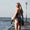 A woman wearing the Zone3 OWS Renew classic swimsuit on a white background.