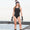 A woman wearing the Zone3 OWS Renew classic swimsuit on a white background.