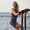 A woman wearing the Zone3 OWS Renew short leg kneeskin swimsuit on a white background.