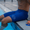 Swimmer in blue FINA Approved Performance Speed jammers sitting at pool edge