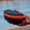 Navy blue protective swim goggle case with a bright orange zipper held by hand.