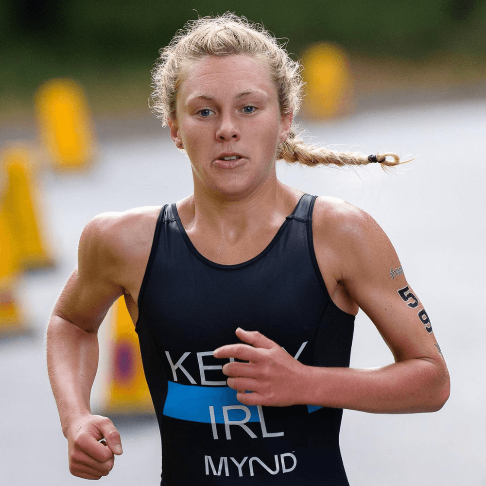 Athlete running with 'Kerril Mynd' tank top in a blurred outdoor setting