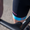 Close-up of the lower leg on the trisuit showing the pink ZONE3 logo on a black panel with a blue hem.
