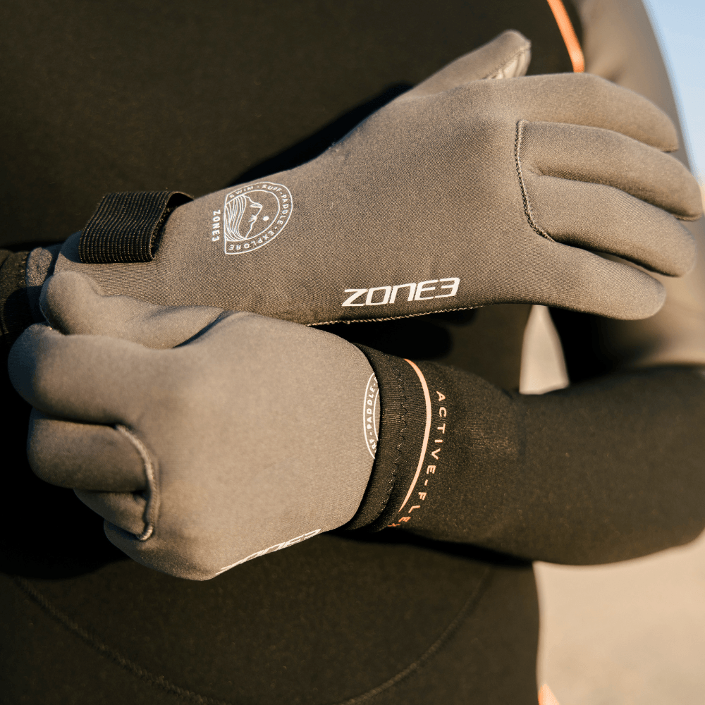 Hands wearing Active-Flex Swim Gloves, providing protection for swimming, surfing, and paddle sports.