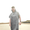Man wearing a Microfibre Changing Robe on the beach, showcasing its lightweight and quick-drying features.