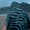 Person wearing a Microfibre Changing Robe with stripes, perfect for outdoor activities and staying dry.