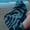 Microfibre Changing Robe being held on the beach, ideal for staying dry and comfortable during outdoor activities.