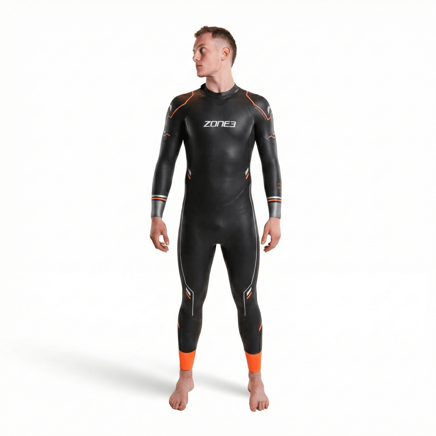 Thermal Aspire wetsuit on male model featuring a black body with orange seam details and orange ankle cuffs