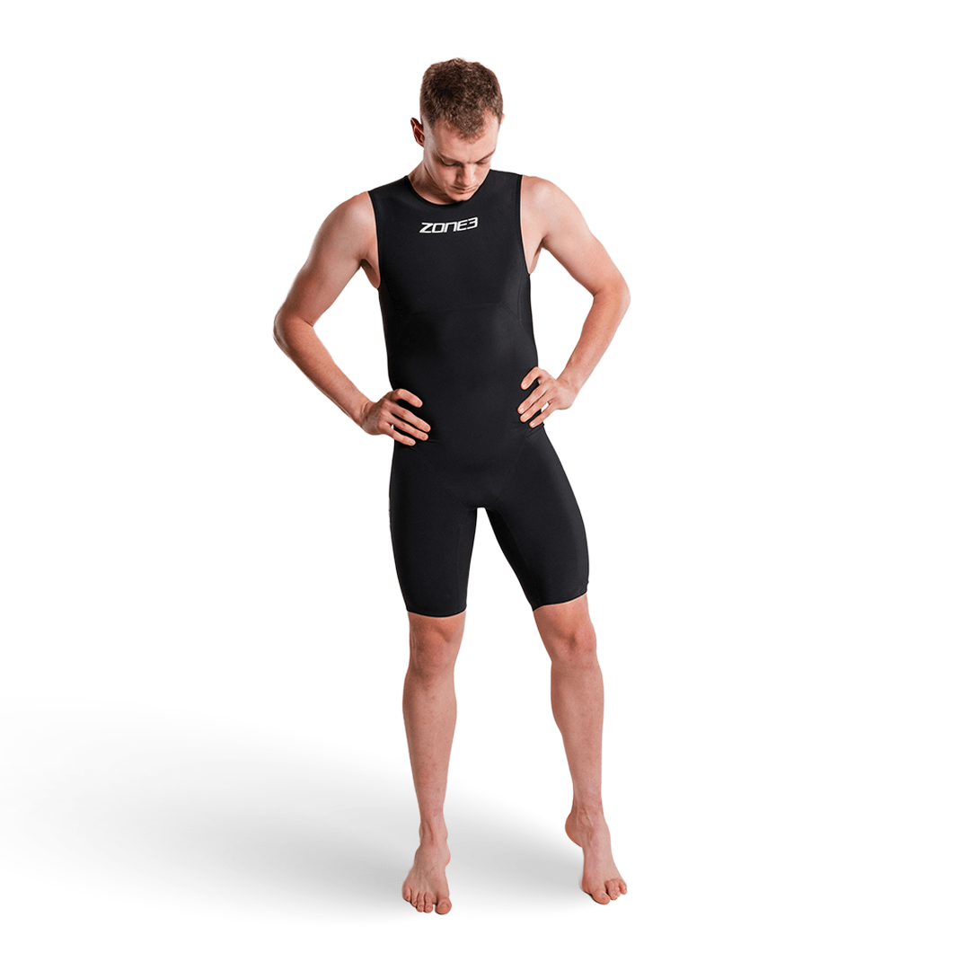 Male model wearing Zone3 Streamline Sleeveless Swimskin in black with logo on the chest, hands on hips.