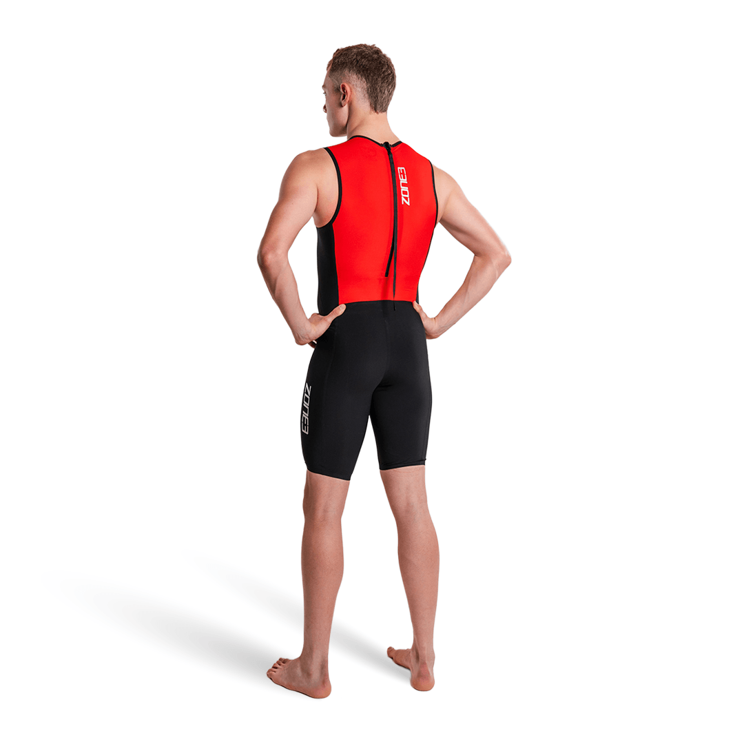 Person wearing a red and black triathlon suit on a white background